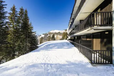a snow covered road in front of a building at Résidence Pollux - maeva Home - Studio 4 personnes - Budget MAE-4213 in Arâches-la-Frasse