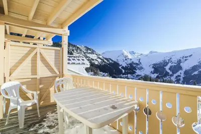 a porch with a table and chairs and mountains at Résidence Le Château de Crans - maeva Home - Studio 4 personnes - Confort MAE-4250 in Flaine