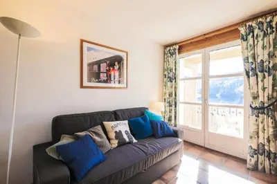 a living room with a couch and a window at Résidence Le Château de Crans - maeva Home - Studio 4 personnes - Confort MAE-4250 in Flaine