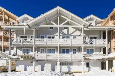 a large white apartment building with a balcony at Résidence Le Château de Crans - maeva Home - Appartement 5 pièces 10 personnes avec sauna privé - Prestige MAE-4441 in Flaine