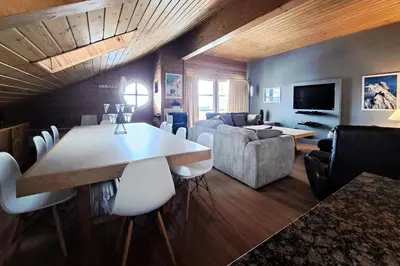 a living room with a table and a couch at Résidence Le Château de Crans - maeva Home - Appartement 5 pièces 10 personnes avec sauna privé - Prestige MAE-4441 in Flaine