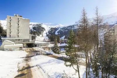 a snow covered road with a building in the background at Résidence Véga - maeva Home - Studio 4 Personnes - Budget MAE-4467 in Arâches-la-Frasse