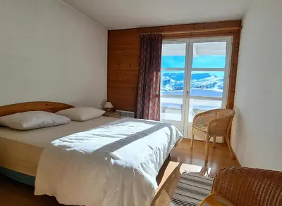 a bedroom with a bed and a large window at Résidence Le Château de Crans - maeva Home - Appartement 3 Pièces 8 Personnes - Confort MAE-4488 in Flaine
