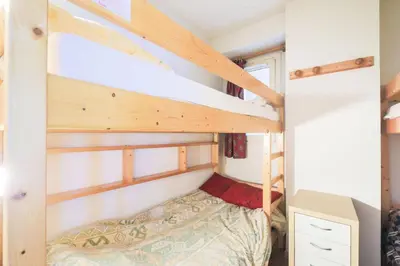 a small bedroom with bunk beds in a tiny house at Résidence Le Château de Crans - maeva Home - Appartement 3 Pièces 8 Personnes - Confort MAE-4488 in Flaine