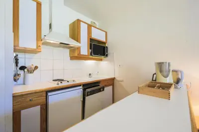 a small kitchen with a sink and a microwave at Résidence Le Château de Crans - maeva Home - Studio 4 Personnes - Confort MAE-4490 in Flaine