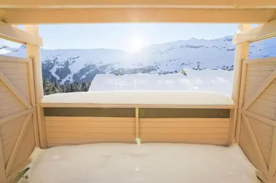a bed in a sauna with a view of mountains at Résidence Le Château de Crans - maeva Home - Studio 4 Personnes - Confort MAE-4490 in Flaine