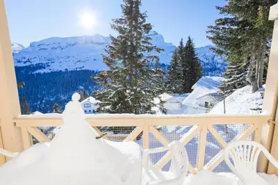a bride and groom standing on a balcony with a view at Résidence Arbaron - maeva Home - Appartement 3 Pièces 8 Personnes - Budget MAE-4591 in Flaine