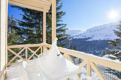 a wedding dress on a chair on a balcony with mountains at Résidence Arbaron - maeva Home - Appartement 3 Pièces 8 Personnes - Budget MAE-4591 in Flaine