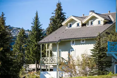 a large white house with a gray roof at Résidence Arbaron - maeva Home - Appartement 3 Pièces 8 Personnes - Budget MAE-4591 in Flaine