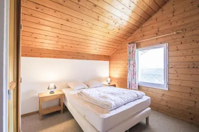 a bedroom with a bed in a wooden room at Résidence Arbaron - maeva Home - Appartement 3 Pièces 8 Personnes - Budget MAE-4591 in Flaine