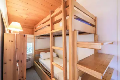 a couple of bunk beds in a room at Résidence Arbaron - maeva Home - Appartement 3 Pièces 8 Personnes - Budget MAE-4591 in Flaine