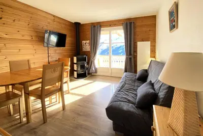 a living room with a couch and a dining room table at Résidence Le Château de Crans - maeva Home - Appartement 2 Pièces 6 Personnes - Sélection MAE-4725 in Flaine