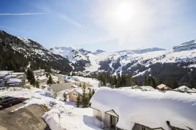 a village covered in snow with mountains in the background at Résidence Le Château de Crans - maeva Home - Appartement 2 Pièces 6 Personnes - Sélection MAE-4725 in Flaine