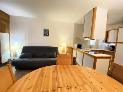 a living room with a couch and a wooden table at Résidence Le Château de Crans - maeva Home - Appartement 2 Pièces 6 Personnes - Sélection MAE-4725 in Flaine