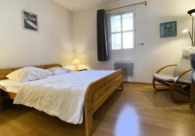 a bedroom with a large bed and a window at Résidence Le Château de Crans - maeva Home - Appartement 2 Pièces 6 Personnes - Sélection MAE-4725 in Flaine
