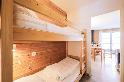 a bedroom with bunk beds in a house at Résidence Le Château de Crans - maeva Home - Appartement 2 Pièces 6 Personnes - Sélection MAE-4725 in Flaine