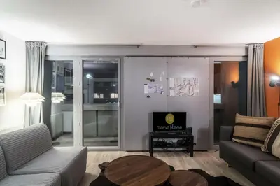 a living room with a couch and a table at Résidence La Petite Ourse - maeva Home - Studio 3 Personnes - Sélection MAE-4901 in Arâches-la-Frasse