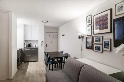 a living room with a table and a kitchen at Résidence La Petite Ourse - maeva Home - Studio 3 Personnes - Sélection MAE-4901 in Arâches-la-Frasse