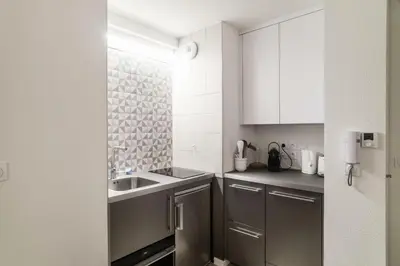 a small kitchen with a sink and a counter at Résidence La Petite Ourse - maeva Home - Studio 3 Personnes - Sélection MAE-4901 in Arâches-la-Frasse