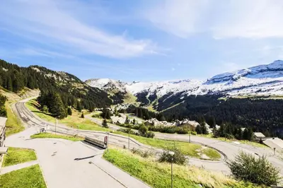 a road in the mountains with snow covered mountains at Résidence Refuge du Golf - maeva Home - Appartement 4 Pièces 8 Personnes - Prestige MAE-5505 in Arâches-la-Frasse