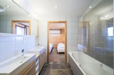 a bathroom with two sinks and a tub and a shower at Résidence Refuge du Golf - maeva Home - Appartement 4 Pièces 8 Personnes - Prestige MAE-5505 in Arâches-la-Frasse