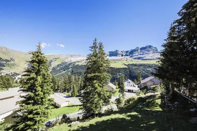 a house on a hill with trees and mountains at Résidence Arbaron - maeva Home - Studio 4 personnes - Confort MAE-8638 in Flaine