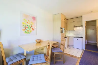 a kitchen with a table and chairs in a room at Résidence Arbaron - maeva Home - Studio 4 personnes - Confort MAE-8638 in Flaine