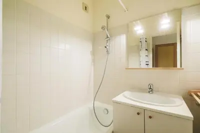 a white bathroom with a sink and a shower at Résidence Arbaron - maeva Home - Studio 4 personnes - Confort MAE-8638 in Flaine