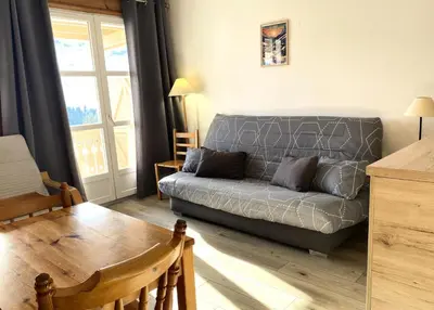 a living room with a couch and a table at Résidence Le Château de Crans - maeva Home - Studio 4 Personnes - Confort MAE-9176 in Flaine