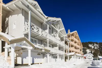 a large white building with snow on the ground at Résidence Le Château de Crans - maeva Home - Studio 4 Personnes - Confort MAE-9176 in Flaine