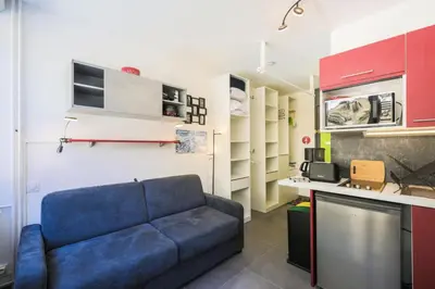 a living room with a blue couch in a kitchen at Résidence Bellatrix - maeva Home - Studio 2 Personnes - Confort MAE-2104 in Flaine