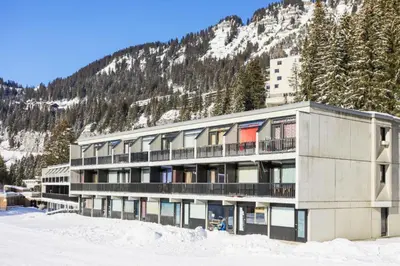 a building in the snow in front of a mountain at Résidence Bellatrix - maeva Home - Studio 2 Personnes - Confort MAE-2104 in Flaine