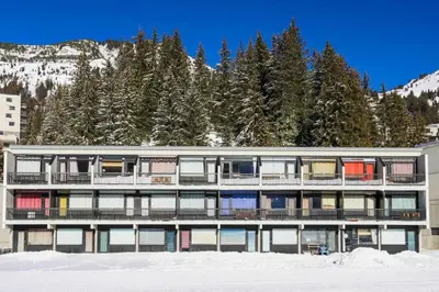 an apartment building with snow in front of a mountain at Résidence Bellatrix - maeva Home - Studio 2 Personnes - Confort MAE-2104 in Flaine