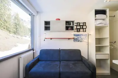 a blue couch in a room with a window at Résidence Bellatrix - maeva Home - Studio 2 Personnes - Confort MAE-2104 in Flaine