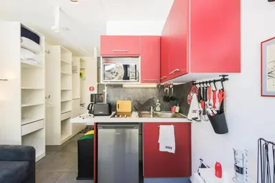 a kitchen with red cabinets and a sink at Résidence Bellatrix - maeva Home - Studio 2 Personnes - Confort MAE-2104 in Flaine