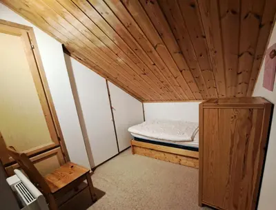 a small room with a bed and a wooden ceiling at Les Chalets de Flaine Hameau - maeva Home - Chalet 5 Pièces 8 Personnes - Sélection MAE-2135 in Flaine