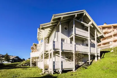 a large white house on a hill at Les Chalets de Flaine Hameau - maeva Home - Chalet 5 Pièces 8 Personnes - Sélection MAE-2135 in Flaine