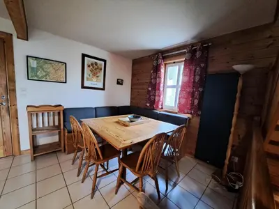 a dining room with a wooden table and chairs at Les Chalets de Flaine Hameau - maeva Home - Chalet 5 Pièces 8 Personnes - Sélection MAE-2135 in Flaine
