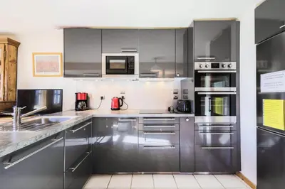 a stainless steel kitchen with stainless steel appliances at Les Chalets de Flaine Hameau - maeva Home - Chalet 5 Pièces 8 Personnes - Sélection MAE-2135 in Flaine