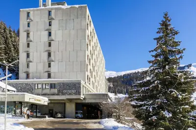 a snow covered pine tree in front of a building at Résidence Cassiopée - maeva Home - Appartement 4 pièces 6 personnes - Confort MAE-3654 in Arâches-la-Frasse