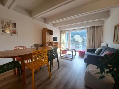 a living room with a table and a couch at Résidence Cassiopée - maeva Home - Appartement 4 pièces 6 personnes - Confort MAE-3654 in Arâches-la-Frasse