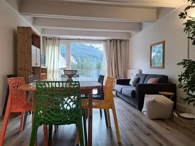 a living room with a table and chairs and a couch at Résidence Cassiopée - maeva Home - Appartement 4 pièces 6 personnes - Confort MAE-3654 in Arâches-la-Frasse