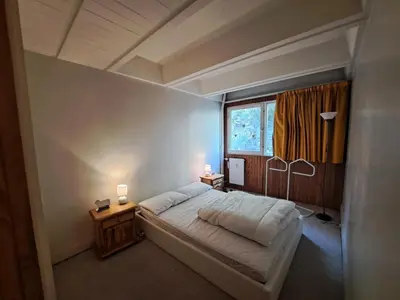 a bedroom with a large bed and a window at Résidence Cassiopée - maeva Home - Appartement 4 pièces 6 personnes - Confort MAE-3654 in Arâches-la-Frasse