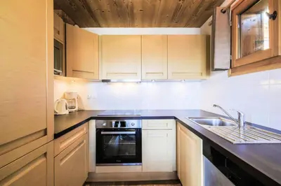 a kitchen with a sink and a stove at Résidence Refuge du Golf - maeva Home - Chalet 4 Pièces 8 Personnes - Prestige MAE-3884 in Arâches-la-Frasse