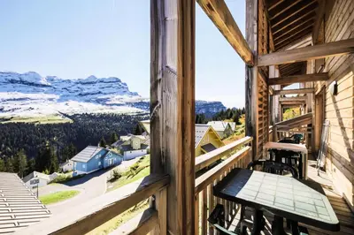 a balcony with a bench and a view of the mountains at Résidence Refuge du Golf - maeva Home - Chalet 4 Pièces 8 Personnes - Prestige MAE-3884 in Arâches-la-Frasse