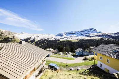 an aerial view of a house with mountains in the background at Résidence Refuge du Golf - maeva Home - Chalet 4 Pièces 8 Personnes - Prestige MAE-3884 in Arâches-la-Frasse