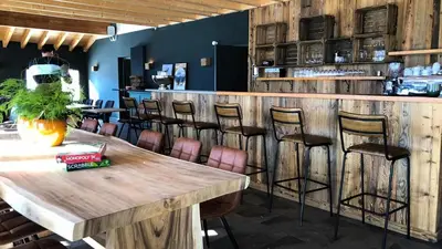a bar with a wooden table and stools at Résidence Refuge du Golf - maeva Home - Chalet 4 Pièces 8 Personnes - Prestige MAE-3884 in Arâches-la-Frasse