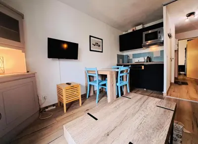 a kitchen with a table and chairs in a room at Résidence Sirius - maeva Home - Studio 4 personnes - Confort MAE-3534 in Arâches-la-Frasse