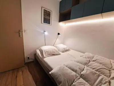 a bedroom with two beds with white sheets and a lamp at Résidence Sirius - maeva Home - Studio 4 personnes - Confort MAE-3534 in Arâches-la-Frasse