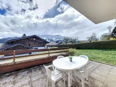a white table and chairs on a patio at Appartement Mont Blanc : 2 chambres, terrasse, parking et équipements modernes - FR-1-560-131 in Demi-Quartier